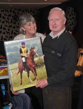 Mike recieving his canvas of Monty from Chair Bridget Brown